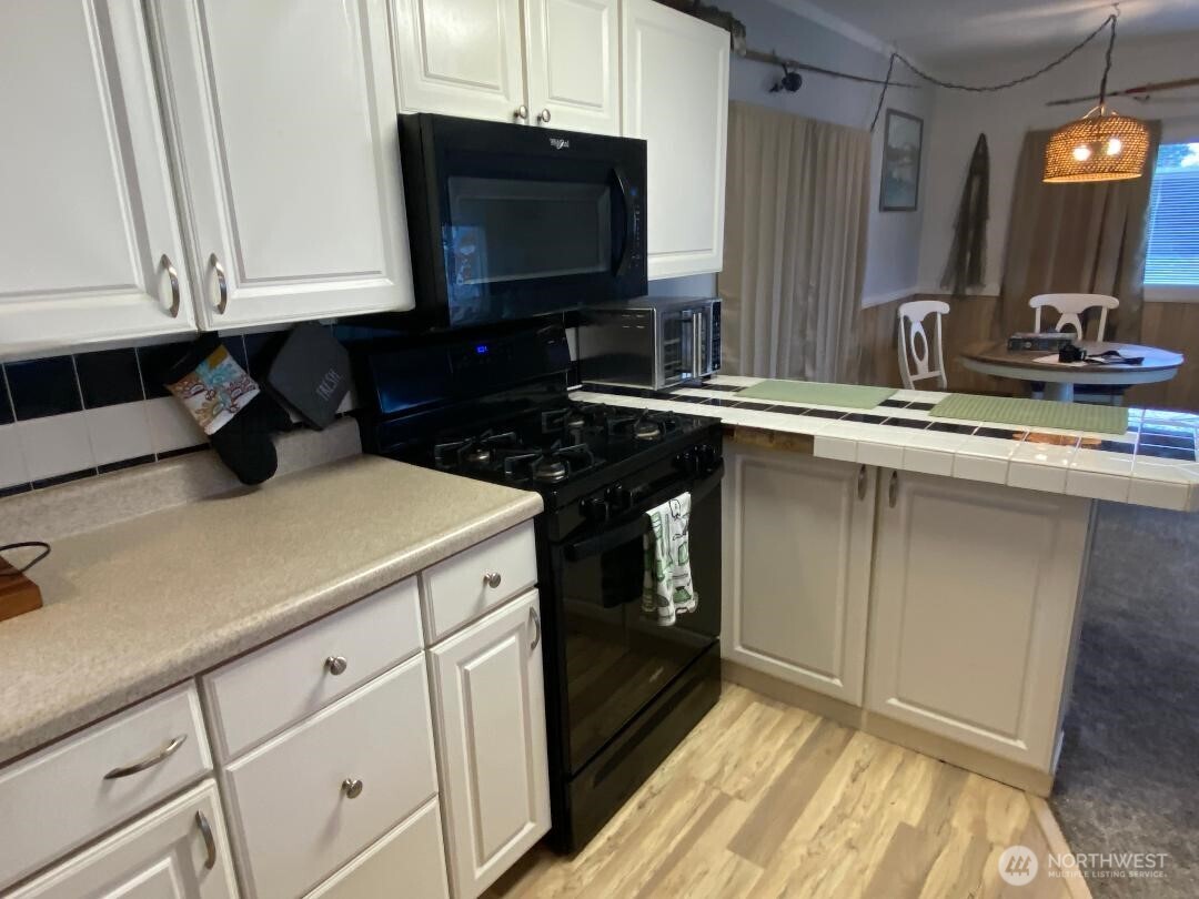 17103 Spanaway Loop Road South, Unit 15 Spanaway, WA 98387 - Photo 6 of 17 a kitchen with a sink and cabinets
