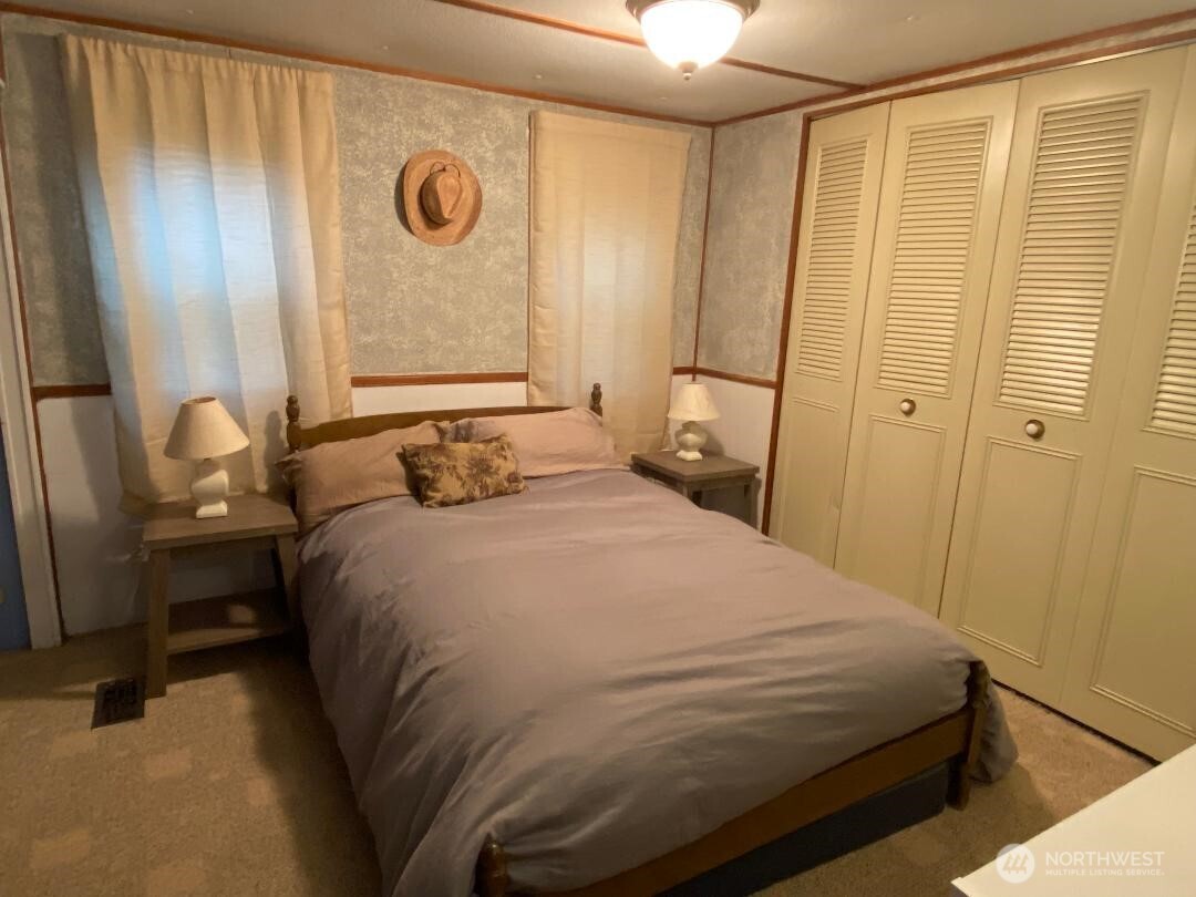 17103 Spanaway Loop Road South, Unit 15 Spanaway, WA 98387 - Photo 9 of 17 a bedroom with a bed and a window