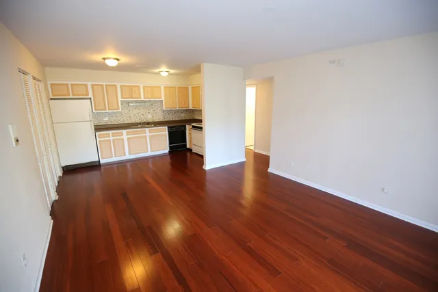 a view of kitchen with wooden floor and electronic appliances