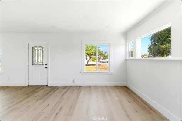an empty room with windows and entrance