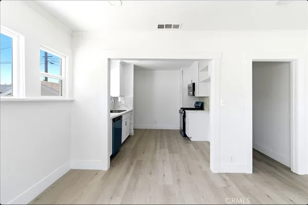 a kitchen with sink cabinets and appliances