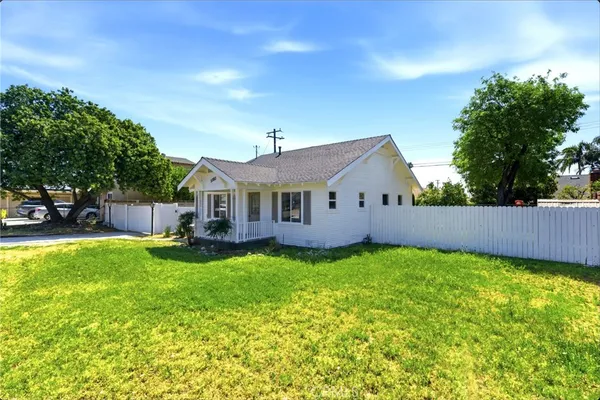 a view of a house with a yard and sitting area
