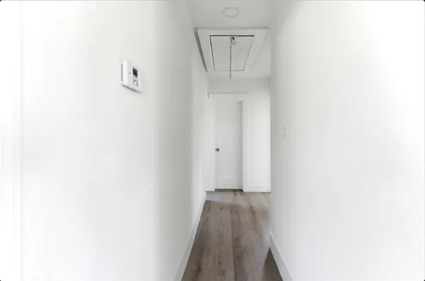 a view of a hallway with wooden floor