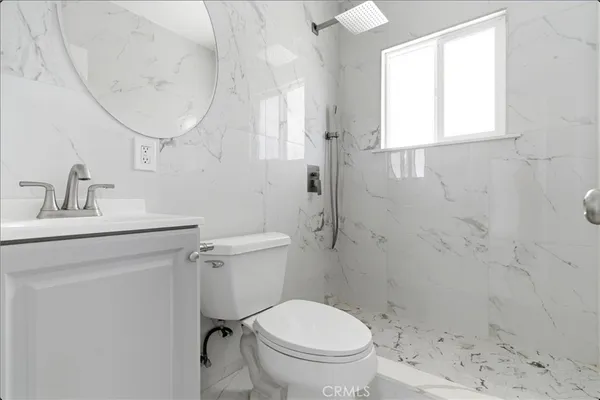 a bathroom with a toilet sink and shower