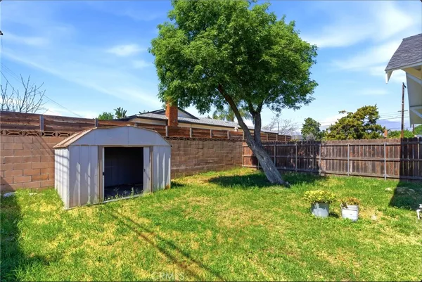 a view of a house with a backyard and a patio
