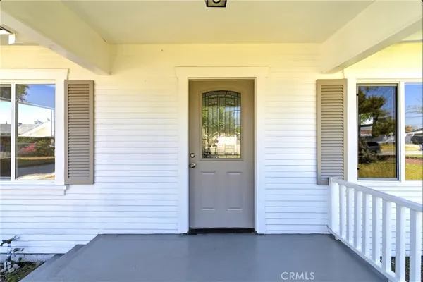 an empty room with windows and wooden floor