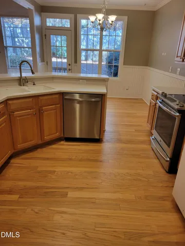 a kitchen with stainless steel appliances granite countertop a sink and a stove