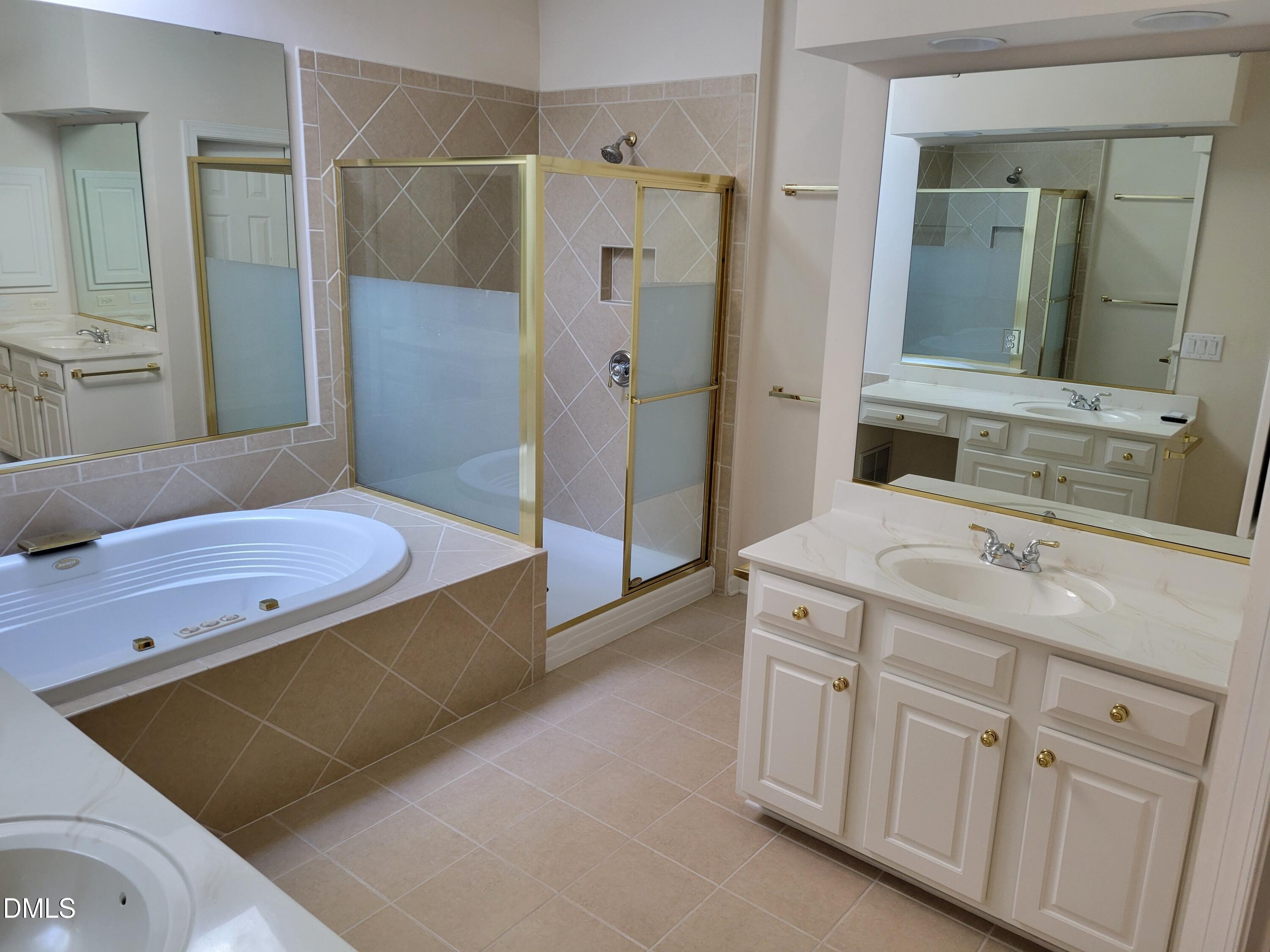 4044 Barton Park Place Raleigh, NC 27613 - Photo 17 of 20 a spacious bathroom with a granite countertop sink a mirror and shower