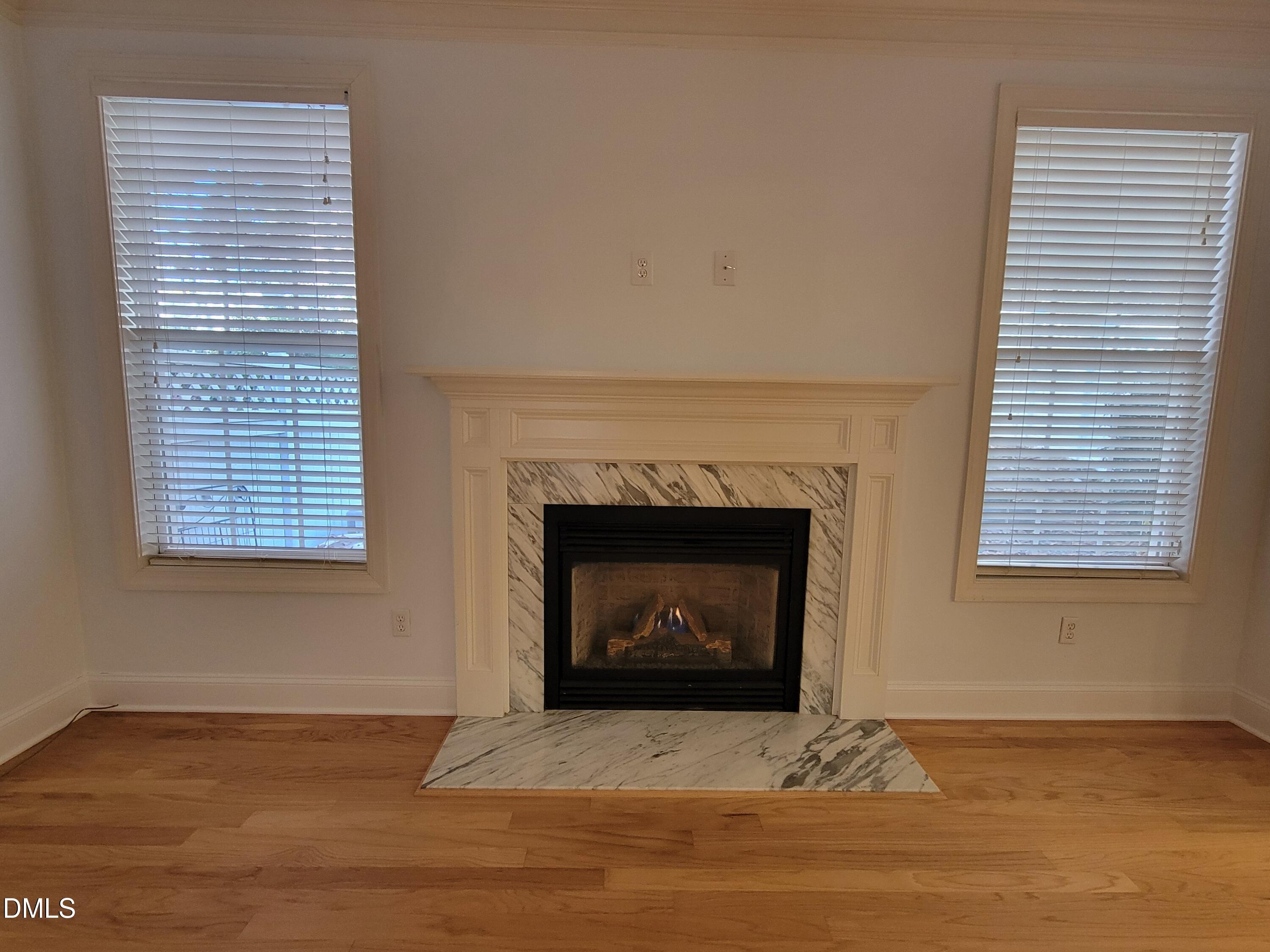 4044 Barton Park Place Raleigh, NC 27613 - Photo 4 of 20 a living room with a fireplace and a floor