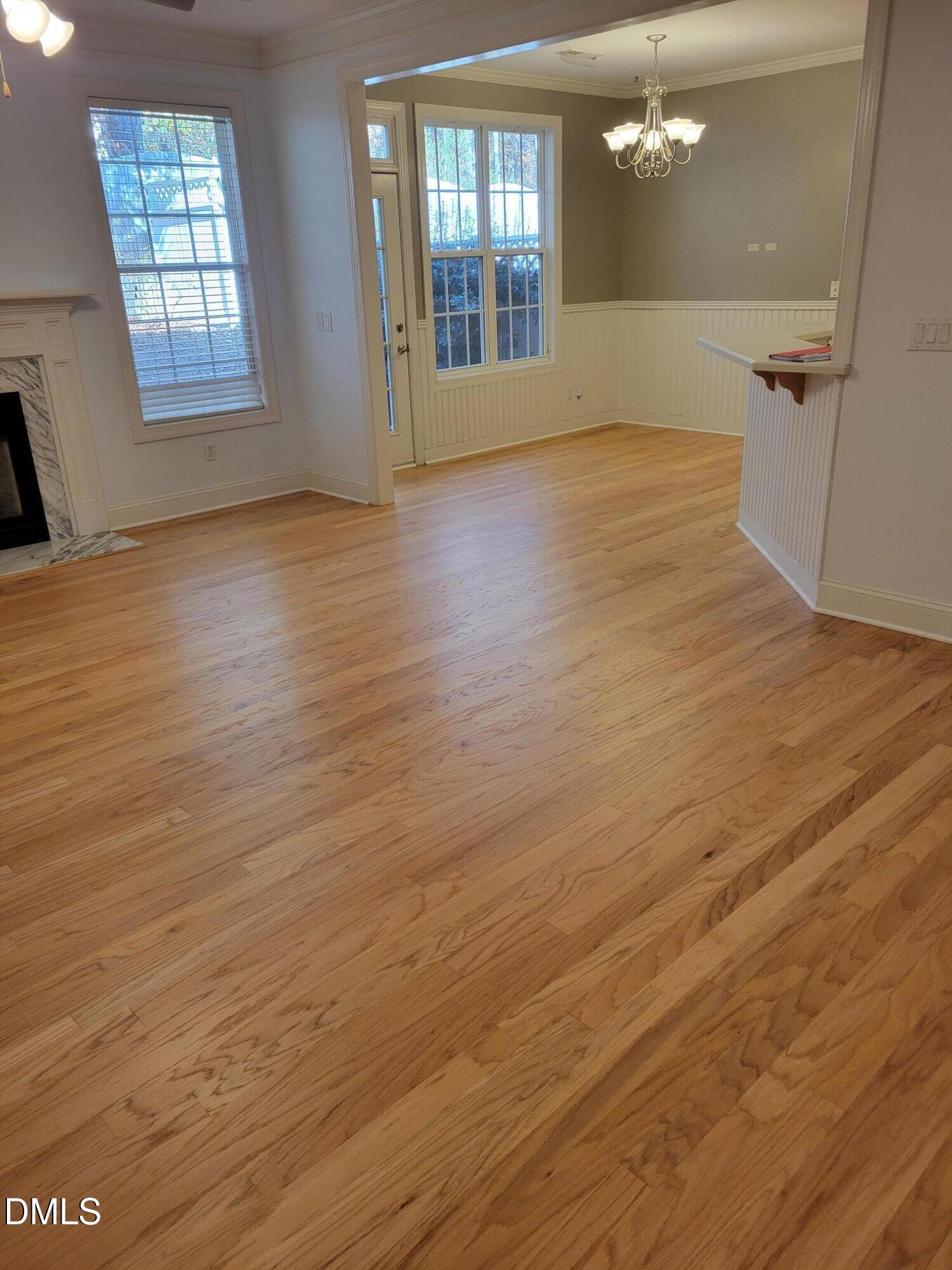 4044 Barton Park Place Raleigh, NC 27613 - Photo 7 of 20 wooden floor in an empty room with a window