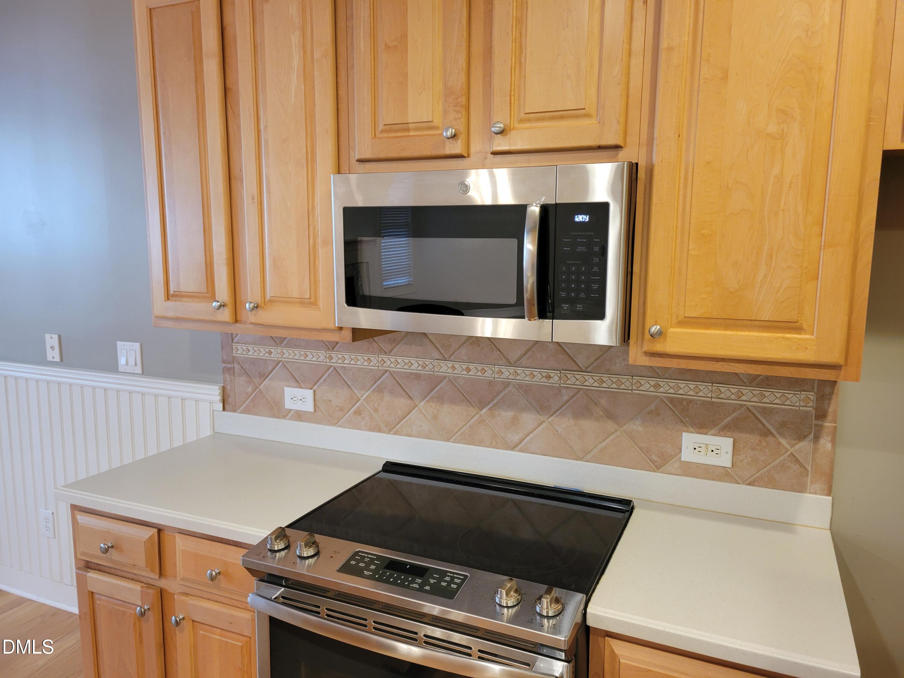 4044 Barton Park Place Raleigh, NC 27613 - Photo 10 of 20 a kitchen with granite countertop a stove and a microwave