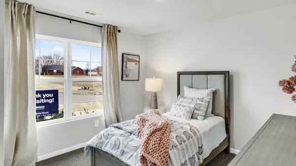 a bedroom with a bed and a mirror