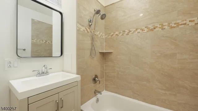 a bathroom with a sink vanity tub and shower