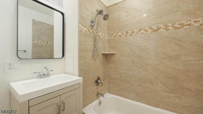 157 West 2nd Avenue Roselle, NJ 07203 - Photo 11 of 19 a bathroom with a sink vanity tub and shower