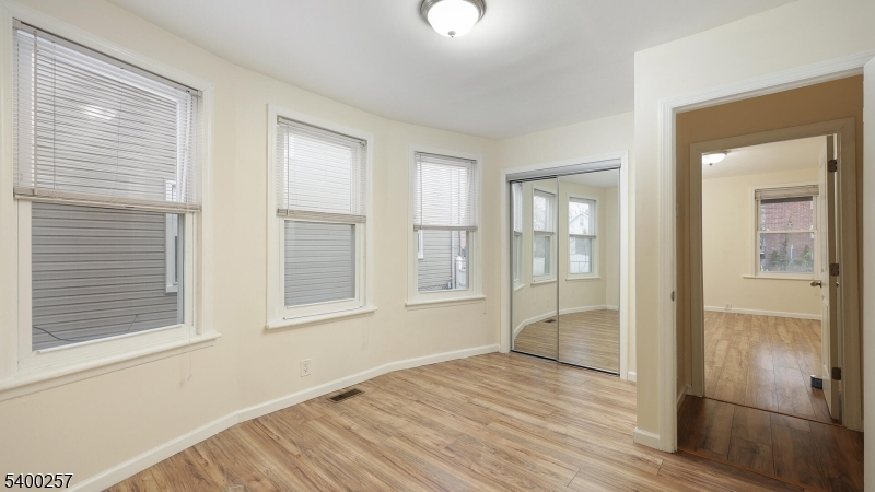157 West 2nd Avenue Roselle, NJ 07203 - Photo 13 of 19 a view of an empty room with wooden floor and windows