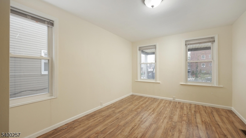 157 West 2nd Avenue Roselle, NJ 07203 - Photo 14 of 19 a view of an empty room with wooden floor and a window