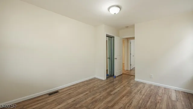 a view of room with wooden floor