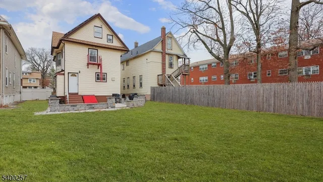 a backyard of a house with table and chairs