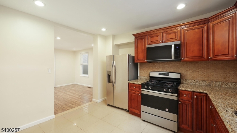 157 West 2nd Avenue Roselle, NJ 07203 - Photo 7 of 19 a kitchen with stainless steel appliances a stove a microwave and sink