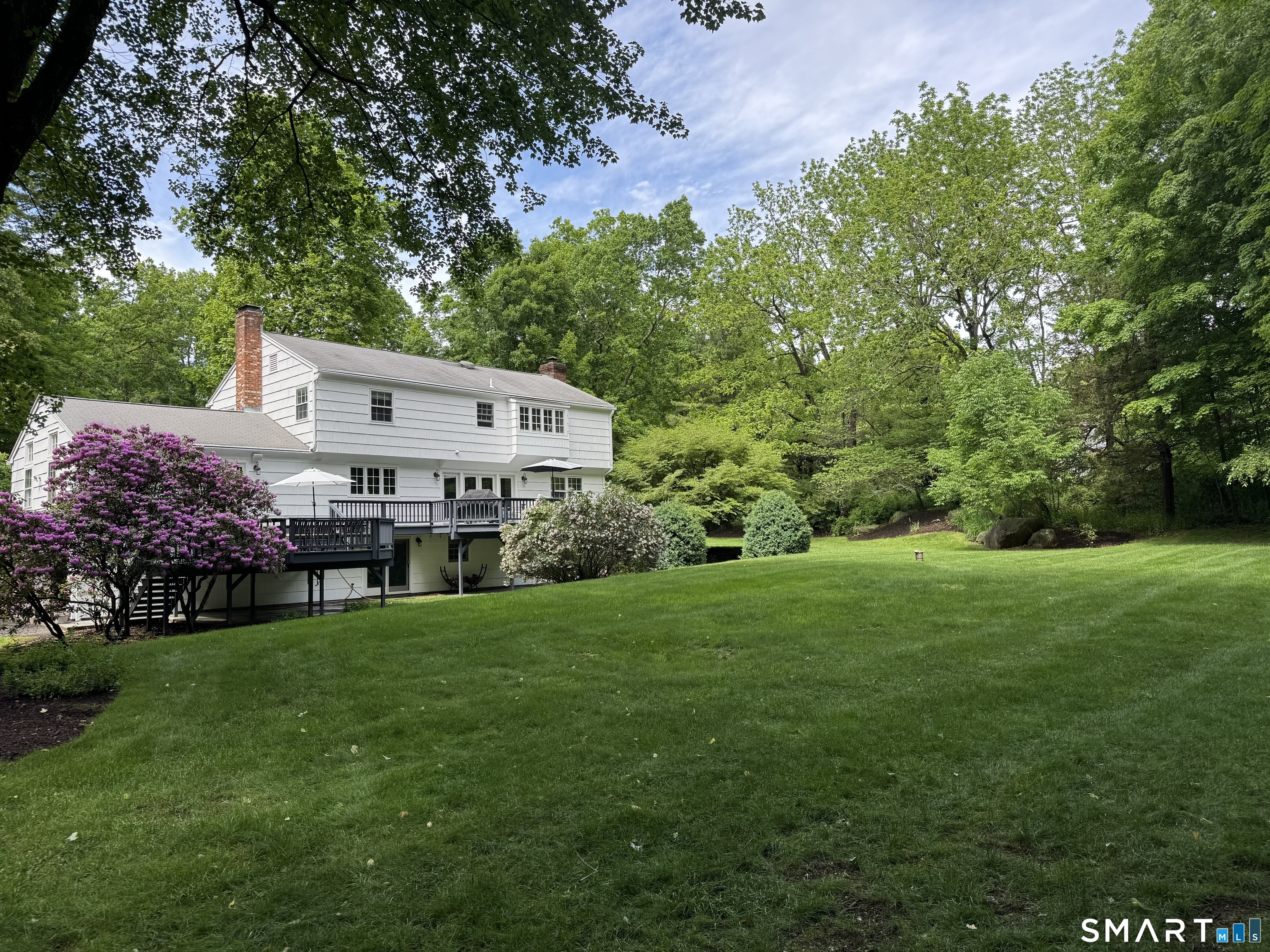 6 Adams Way Weston, CT 06883 - Photo 36 of 40 The landscaping is mature and beautiful - check out the flowering rhododendron and lilac tree.