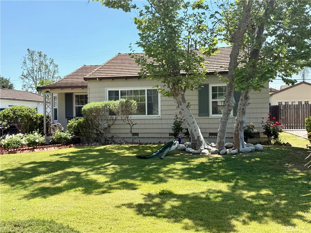 a view of a house with a yard patio and fire pit