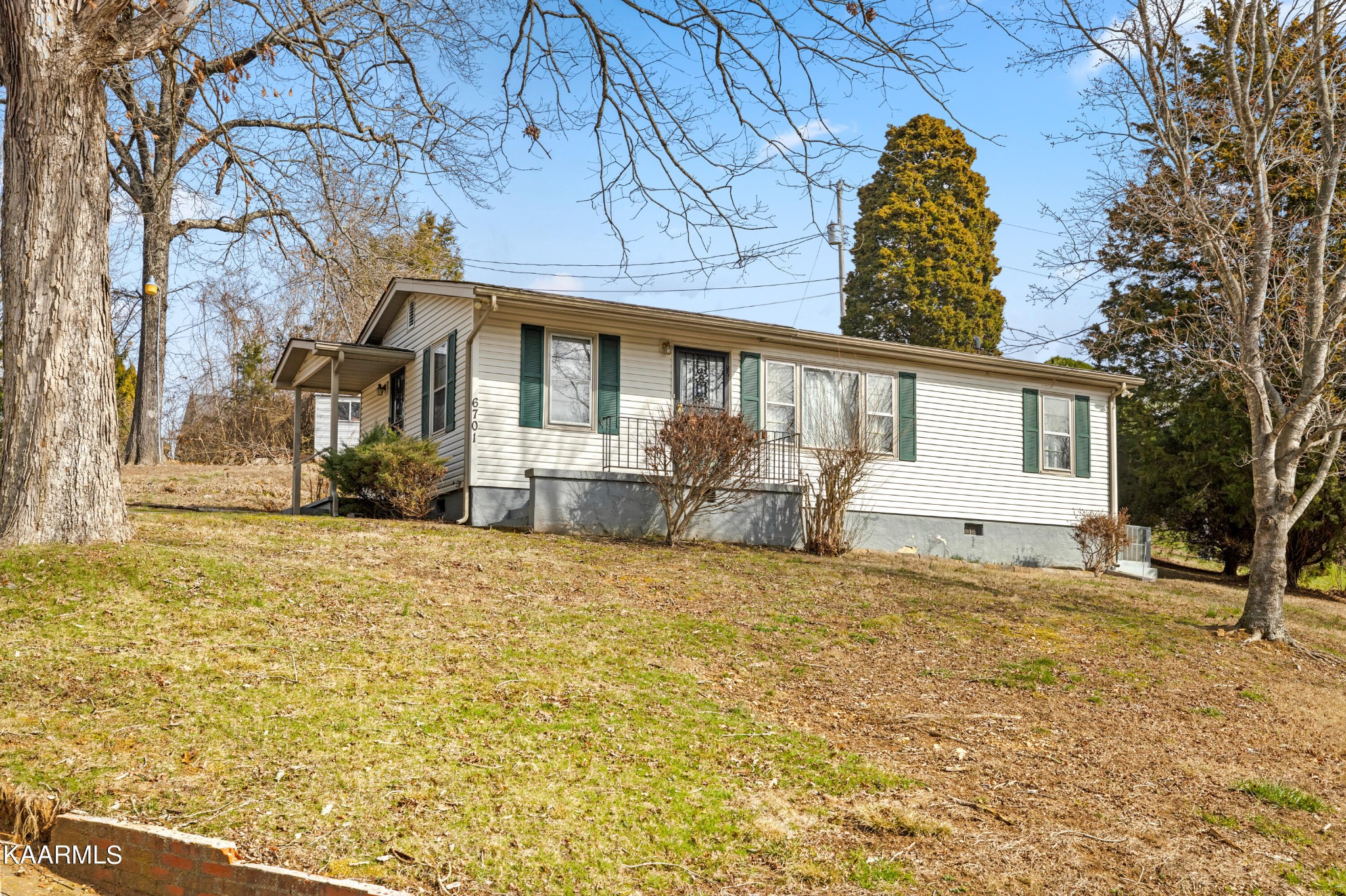 6701 Cate Road Powell, TN 37849 - Photo 2 of 18 a front view of a house with a yard and garage