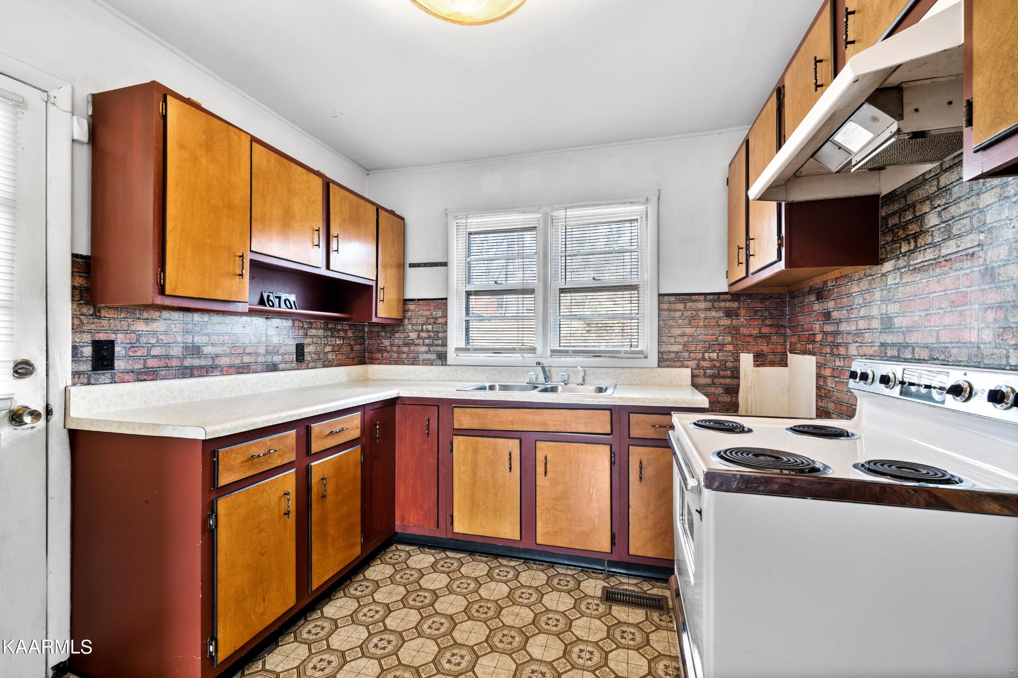 6701 Cate Road Powell, TN 37849 - Photo 6 of 18 a kitchen with stainless steel appliances granite countertop a sink stove and cabinets