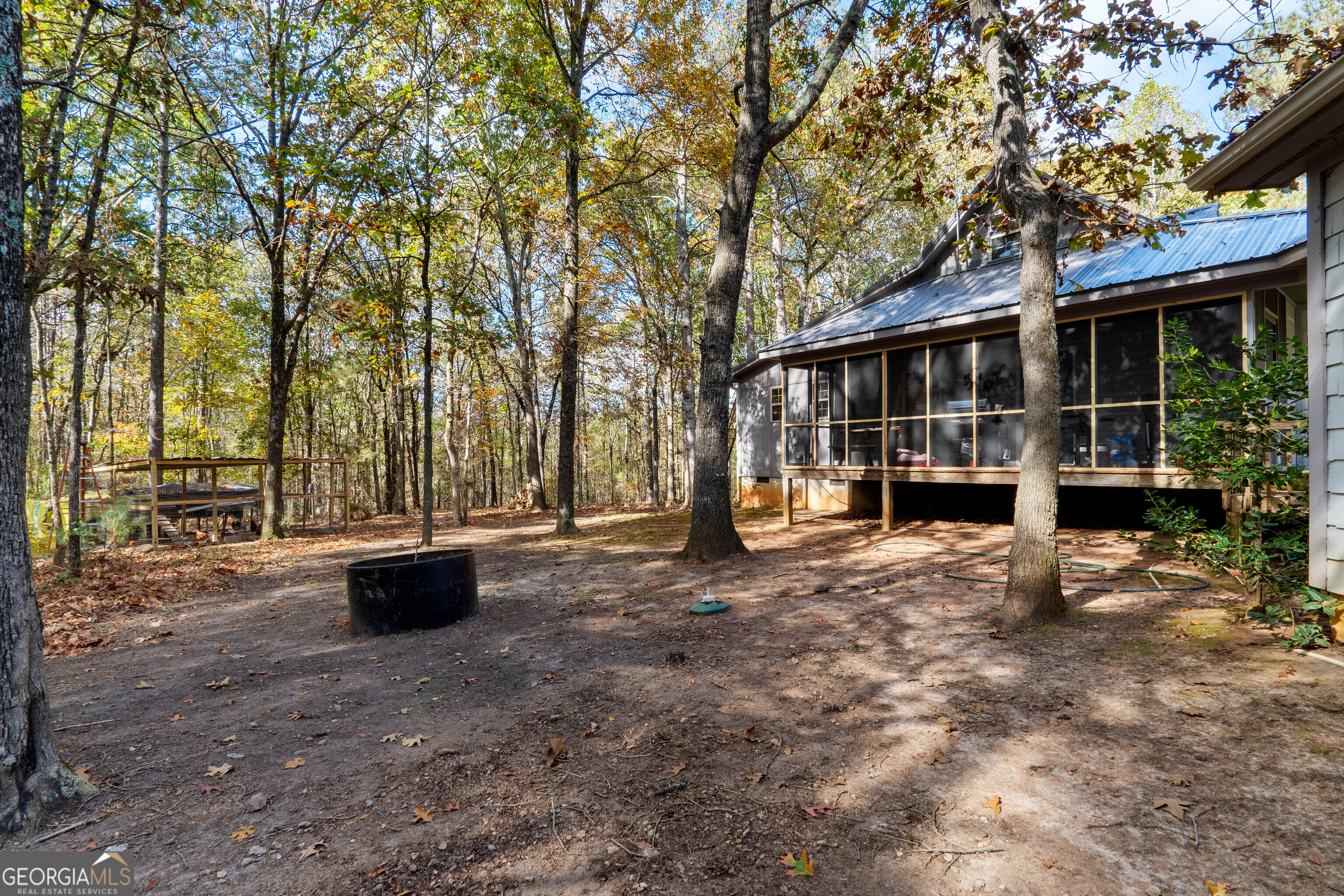 335 Gum Creek Road Roopville, GA 30170 - Photo 11 of 56 a view of backyard with swimming pool and outdoor seating