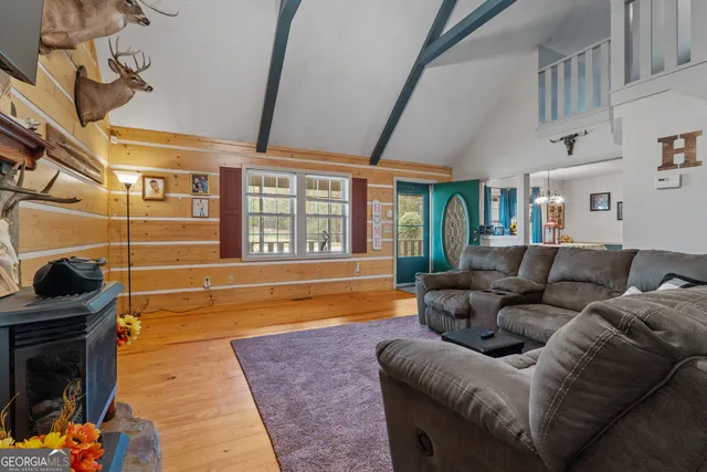 a living room with kitchen island dining table and wooden floor