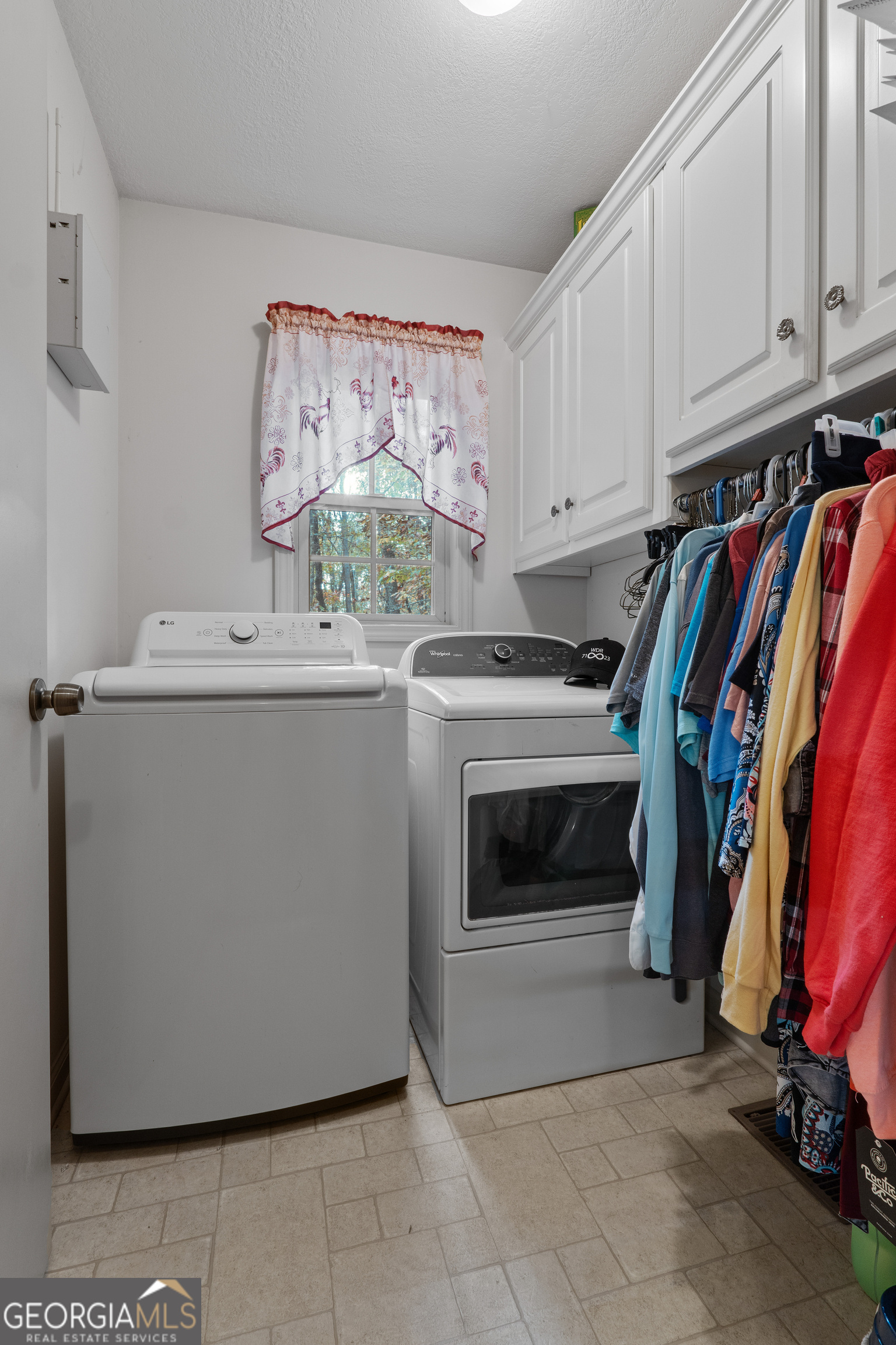 335 Gum Creek Road Roopville, GA 30170 - Photo 39 of 56 a view of a storage and utility room with washer and dryer