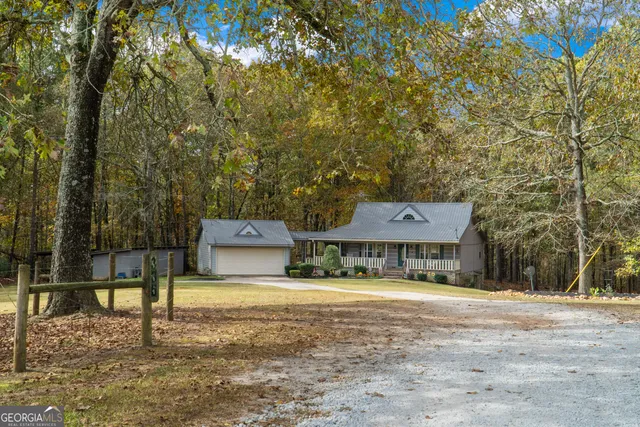 a view of backyard with swimming pool and outdoor seating