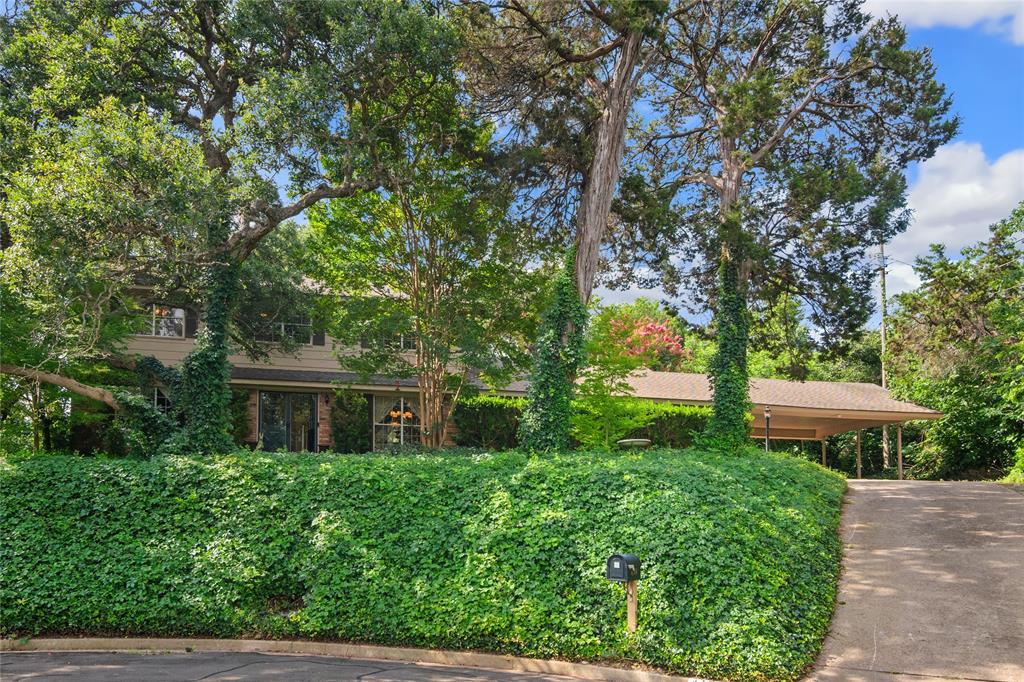 a view of a house with a yard and a tree