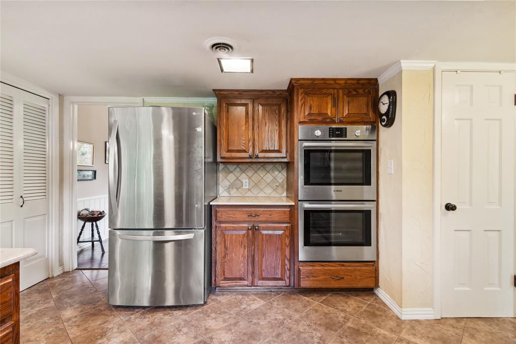 4104 Evergreen Drive Waco, TX 76708 - Photo 11 of 36 a kitchen with stainless steel appliances granite countertop a refrigerator and a stove top oven
