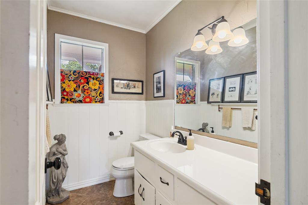 4104 Evergreen Drive Waco, TX 76708 - Photo 16 of 36 a bathroom with a sink a toilet and a mirror