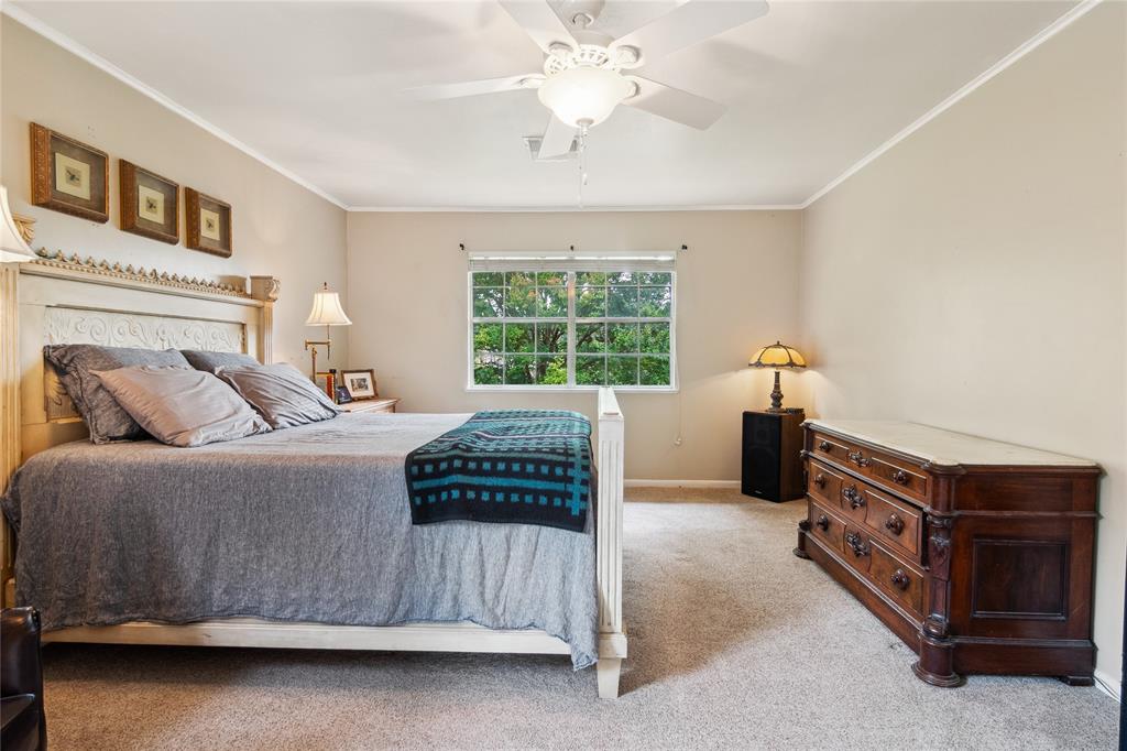 4104 Evergreen Drive Waco, TX 76708 - Photo 21 of 36 a bedroom with a bed and a chandelier