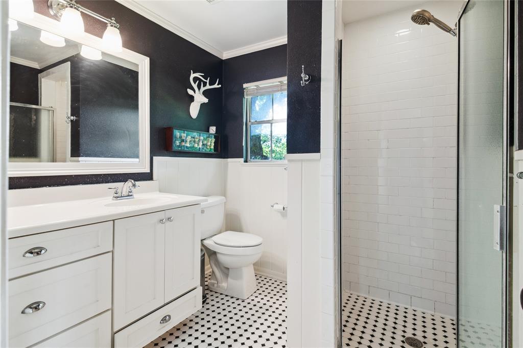 4104 Evergreen Drive Waco, TX 76708 - Photo 24 of 36 a bathroom with a sink a toilet a shower and a mirror