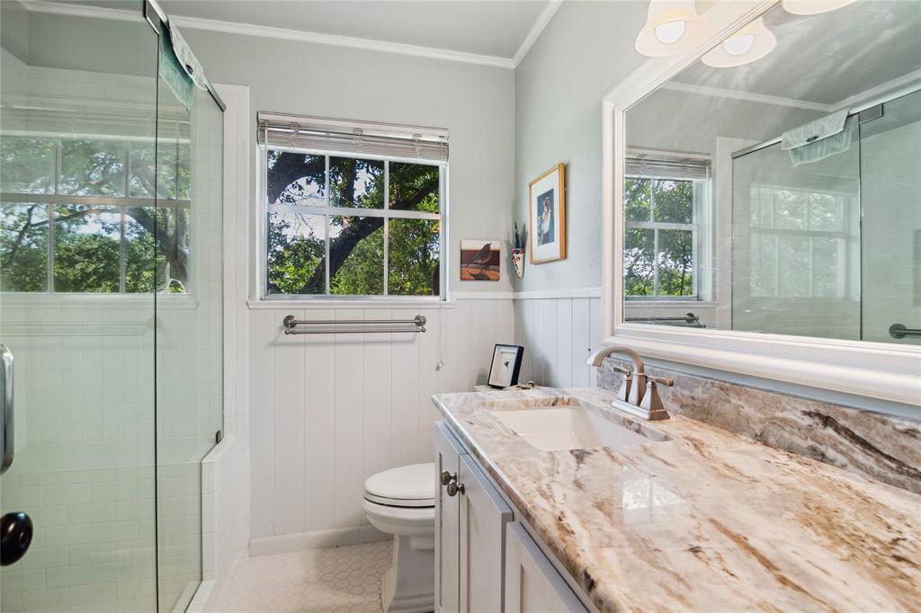 4104 Evergreen Drive Waco, TX 76708 - Photo 25 of 36 a bathroom with a granite countertop sink a toilet and shower