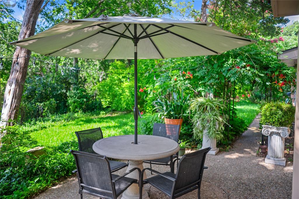 4104 Evergreen Drive Waco, TX 76708 - Photo 32 of 36 a backyard of a house with table and chairs under an umbrella