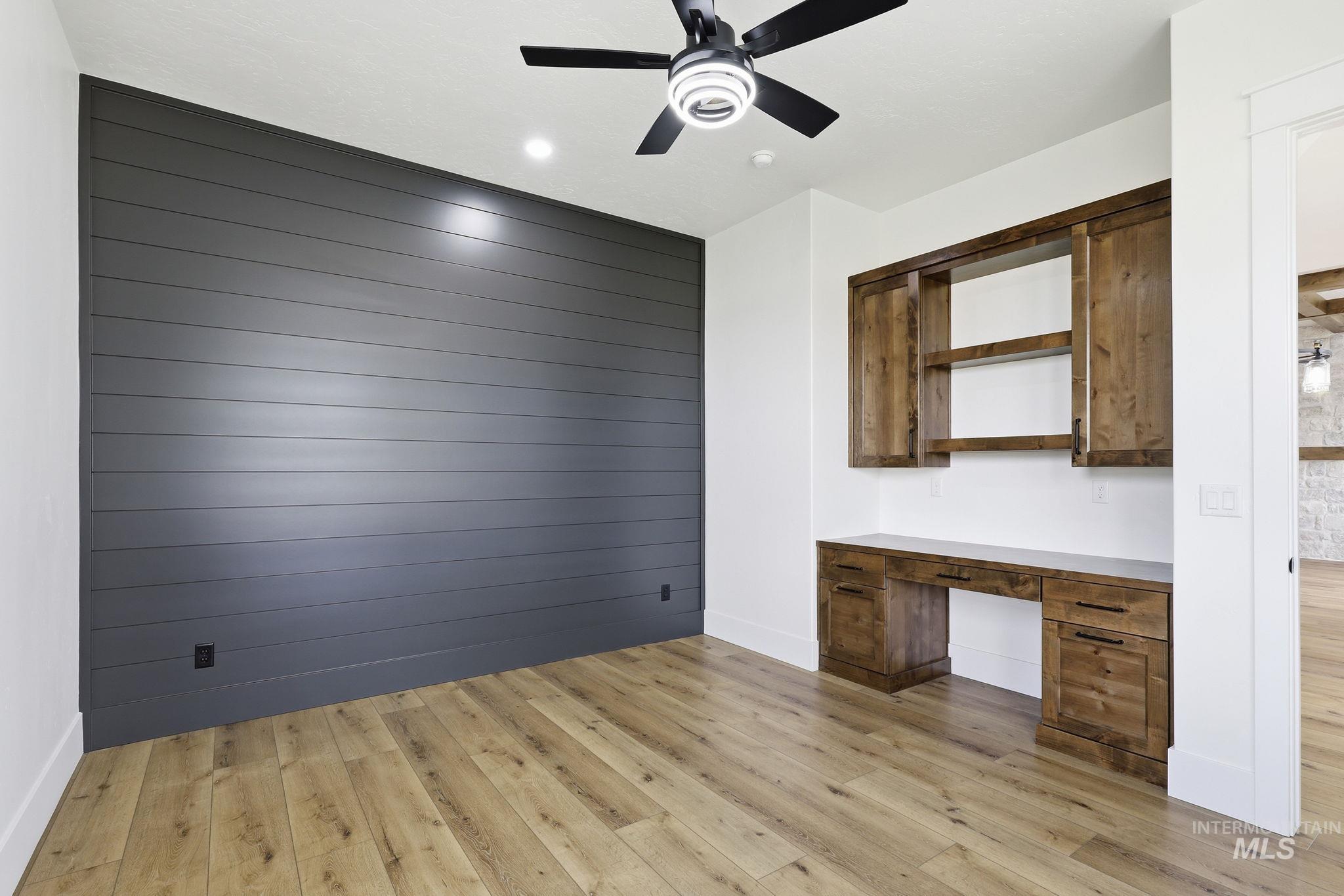 2321 Lower Bluff Road Emmett, ID 83617 - Photo 5 of 31 Entryway featuring wood-finish flooring, white walls, and a black accent wall with vertical slat detailing