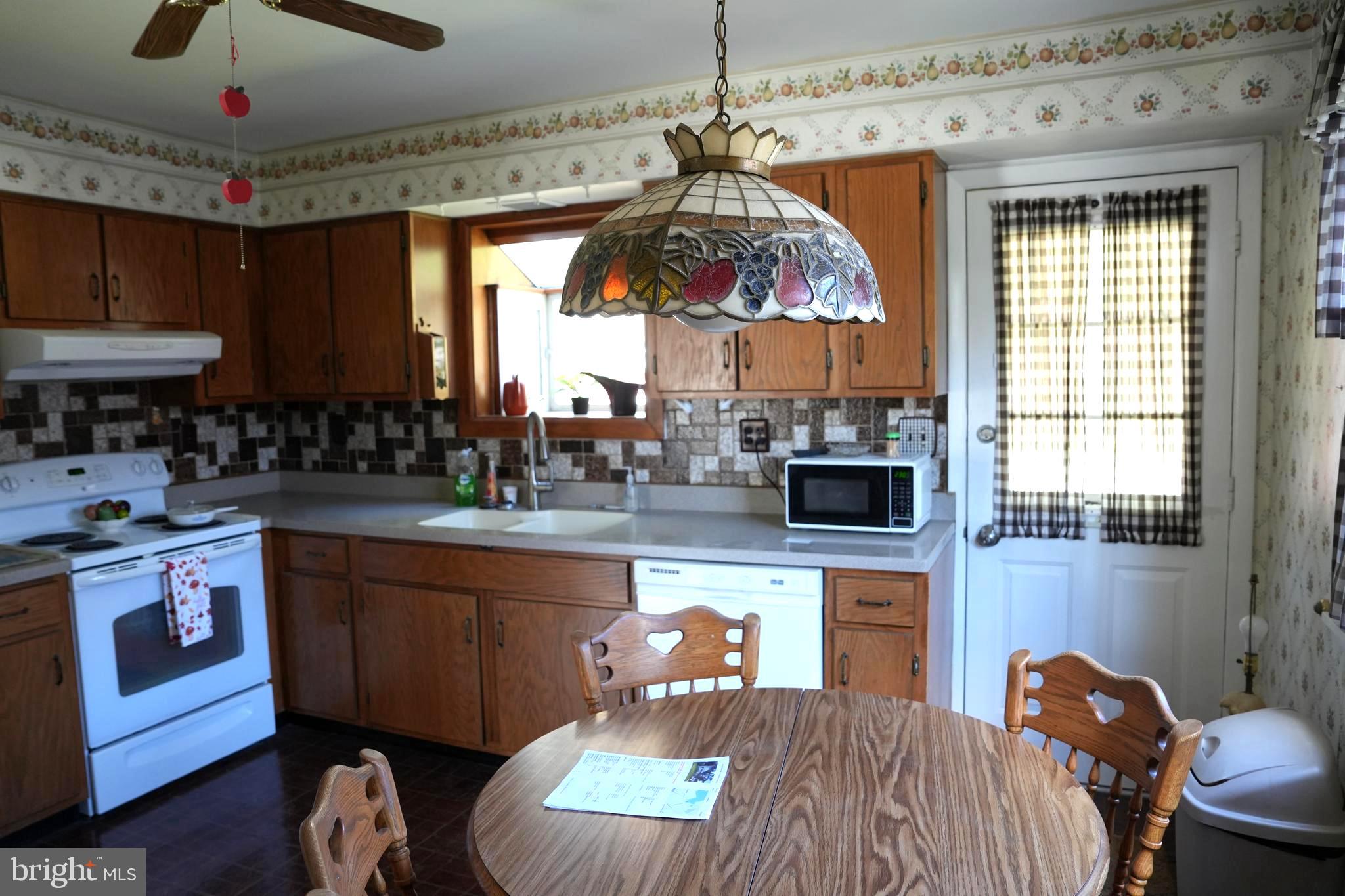 4741 River Road Pennsauken, NJ 08110 - Photo 13 of 26 a kitchen with stainless steel appliances granite countertop a stove a sink dishwasher and a dining table with the kitchen view