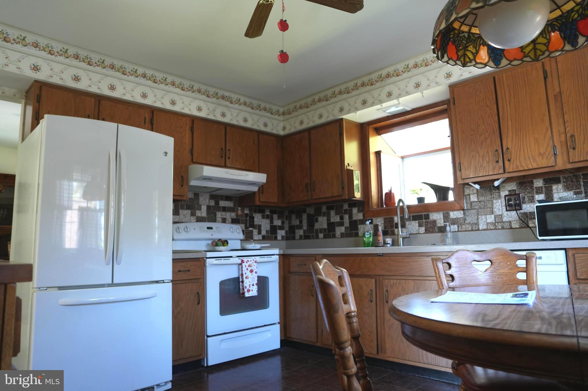 4741 River Road Pennsauken, NJ 08110 - Photo 14 of 26 a kitchen with a dining table chairs and refrigerator