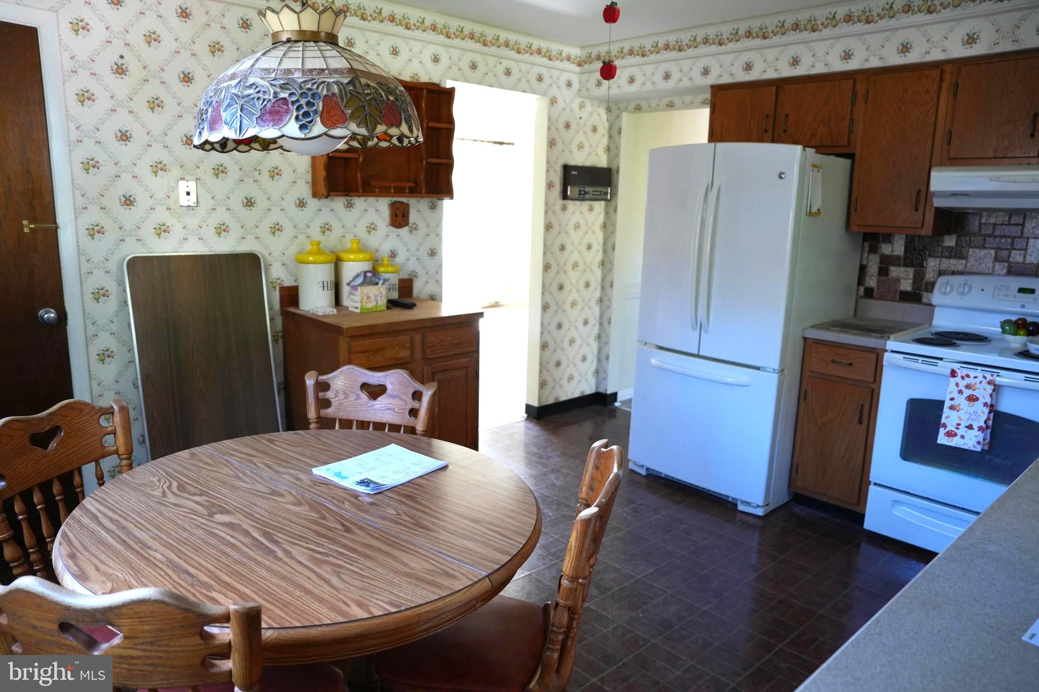 4741 River Road Pennsauken, NJ 08110 - Photo 16 of 26 a kitchen with stainless steel appliances wooden floor dining table and chairs