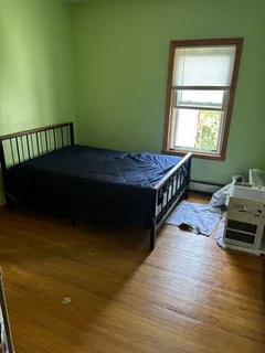 a bedroom with a bed windows and a window