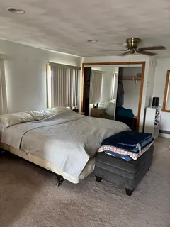 a bedroom with bed and window