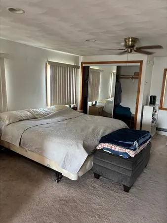 a bedroom with bed and window