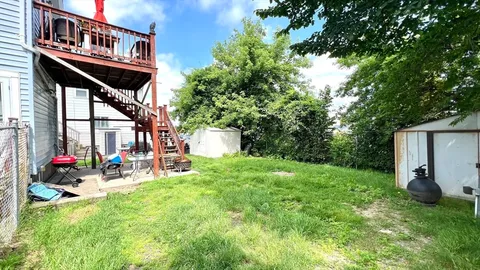 a view of a chairs and tables in the back yard of the house