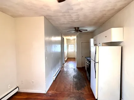 a view of hallway with wooden floor