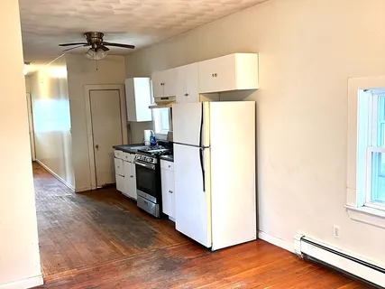 a kitchen with a refrigerator and a stove