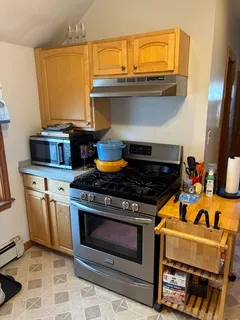 a stove top oven sitting inside of a kitchen