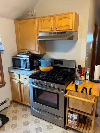 a stove top oven sitting inside of a kitchen